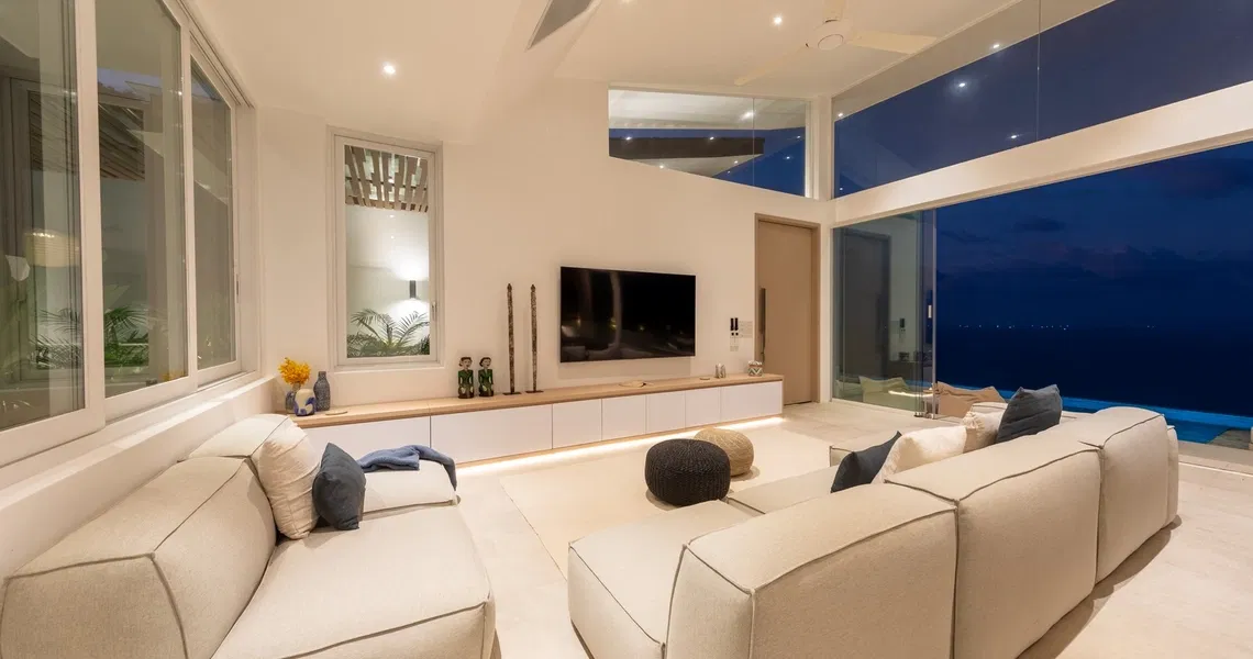 Pacific Palisade Samui luxury villa - living room at night