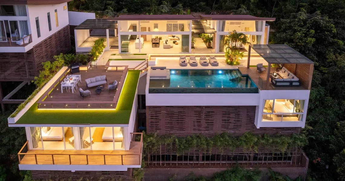 Pacific Palisade Samui luxury villa - frontal drone view at night